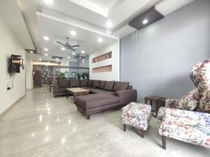 a living room with a couch and chairs at MOON3BHK By Wabi Sabi Stays in Mussoorie