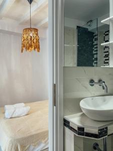 a bathroom with a sink and a mirror at Evagelias suite in Skopelos Town