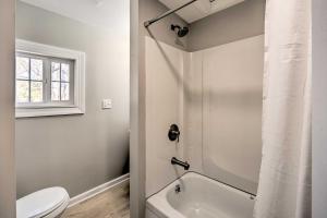 a white bathroom with a toilet and a sink at Sunny Superior Home - Swim, Hike, and Explore! in Superior +28 photos