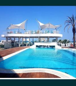 a large swimming pool with a building in the background at White Tower Mamaia Apartament Privat 503 in Mamaia