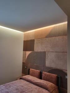a bedroom with a bed with two pillows at Casa Stazione Pescara in Pescara