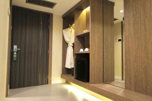 a dressing room with a mannequin in a cabinet at Hermann Hotel Pattaya - SHA Extra Plus in Pattaya Central