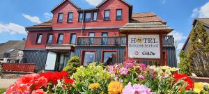 a house with a flower garden in front of it at Hotel Schneiderhof in Braunlage +193 photos