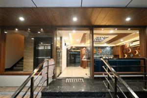 a stairway leading to a building with glass doors at Hotel Hallmark By THC Group in Kota
