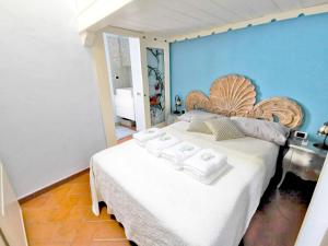 a bedroom with a large bed with towels on it at Wonderful Penthouse in the Heart of Milan in Milan