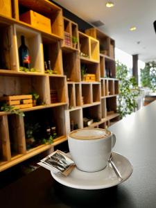 una tazza di caffè su un piatto su un tavolo di VENEZIANA Boutique Hotel Superior a Capodistria