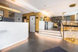 a living room with a staircase and a lobby at Prince Albert Lyon Bercy in Paris