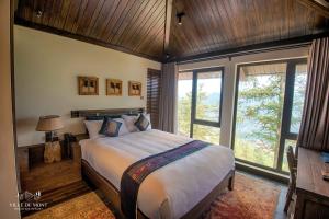 a bedroom with a large bed in a room with windows at Ville De Mont Mountain Resort in Sa Pa +92 photos