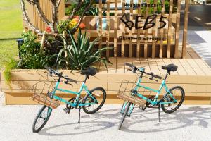 two bikes are parked in front of a store at BEB5 Okinawa Seragaki by Hoshino Resorts in Onna