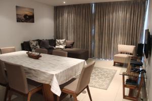 a living room with a table and a couch at Beacon Rock - 6 sleeper Luxurious Apartment in Durban