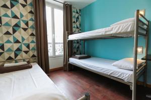 a room with two bunk beds and a window at Oops! Latin quarter by Hiphophostels in Paris