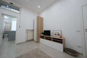 Televízia a/alebo spoločenská miestnosť v ubytovaní Gramsci Luxury apartment By Dimorra