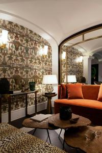 a living room with a couch and a patterned wall at Eight Hotel Portofino in Portofino