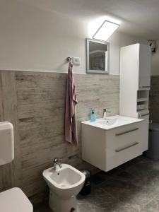 a bathroom with a white sink and a toilet at Apartma Ročica in Kobarid