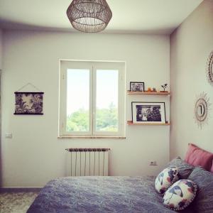 a bedroom with a bed and a window at Villa Cimina in Caprarola