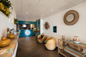 a store with bowls and vases on the walls at Hôtel Restaurant Splendid Camargue in Le Grau-du-Roi