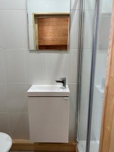 a white bathroom with a sink and a shower at Luxury Guest House in the Centre of Argeles Gazost in Argelès-Gazost