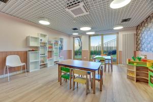 a childrens room with a table and chairs at Nadmotławie Riverside - Gym & Free Parking by Downtown Apartments in Gdańsk