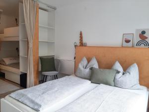 a bedroom with a large white bed with pillows at Apartman Ramsau in Ramsau am Dachstein