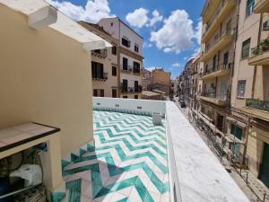 a view from the balcony of a building with a tile floor at Casa viotti Le fuoriserie in Palermo
