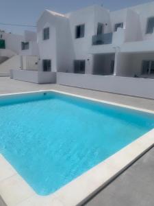 a large swimming pool in front of a building at Apartment 1 Rociega 35 Puerto del Carmen in Puerto del Carmen
