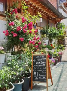 a sign in front of a flower shop with flowers at Yeon Dang Guesthouse in Seoul