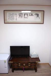 a wooden table with a television on top of it at Yeon Dang Guesthouse in Seoul