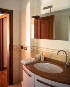 a bathroom with a sink and a mirror at La Casetta, appartamento con vista lago e montagne in San Zeno di Montagna