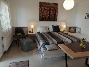 a bedroom with a bed and a table and a chair at Stella Mare in Tučepi