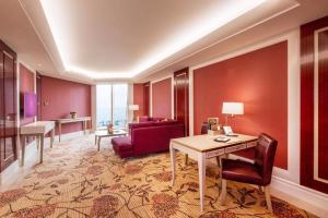 a living room with a table and a red couch at Okada Manila in Manila