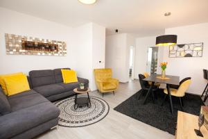 a living room with a couch and a table at Luxury apartment Eva in Zadar