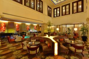 a hotel lobby with couches and tables at Hotel Equatorial Ho Chi Minh City in Ho Chi Minh City