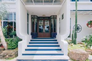 a front door of a house with blue stairs at Sugar Marina Hotel - NAUTICAL - Kata Beach - SHA plus in Kata Beach