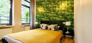 a bedroom with a bed with a green wall at Apartament nad Zalewem in Serock +17 photos