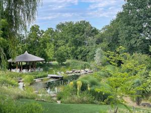a garden with a gazebo and a pond at Living in Frames in Neusiedl bei Güssing