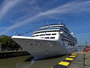 a large cruise ship is docked in the water at Ferienwohnung an Schleusenanlage NOK in Brunsbüttel