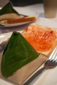 a plate with a piece of toast and a knife and fork at Hotel Jelai @ Mentakab in Mentekab