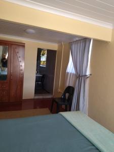 a bedroom with a bed and a window and a desk at Rebanien2 Overnight Accommodation Double and Single bed in De Aar