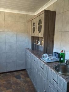 a kitchen with a sink and a counter at Rebanien2 Overnight Accommodation Double and Single bed in De Aar