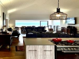 a kitchen and living room with a stove top at Oyster Bay Ten On Tornyn in Oyster Bay