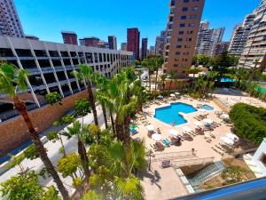 an aerial view of a hotel with a pool and palm trees at Hotel Servigroup Castilla in Benidorm