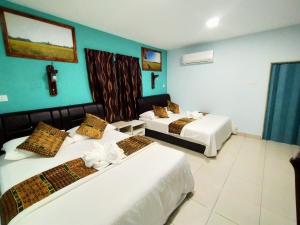 Postel nebo postele na pokoji v ubytování Langkawi Country Lodge2