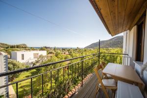 a balcony with a table and chairs and a view at Karia Apart&Pension in Mesudiye