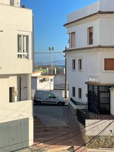 a car parked in a parking lot between two buildings at Casa Tajo in Tarifa