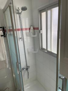 a shower with a glass door in a bathroom at Casa Tajo in Tarifa