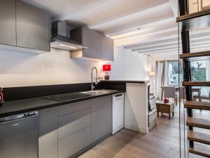 a kitchen with white cabinets and a sink at Maison Méribel, 3 pièces, 6 personnes - FR-1-566-21 in Les Allues