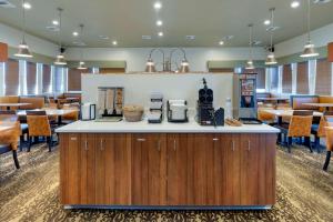 a restaurant with a counter and tables and chairs at Best Western King Salmon Inn in Soldotna