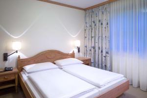 Postel nebo postele na pokoji v ubytování Dorint Sporthotel Garmisch-Partenkirchen