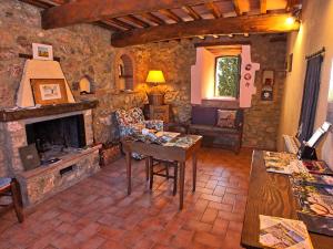 a living room with a fireplace and a stone wall at Agriturismo Colli di Travale in Montieri
