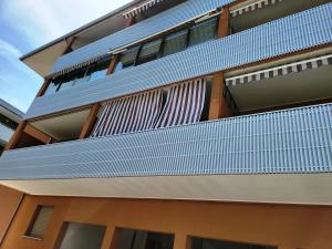 an external view of a building with blue balconies at Monolocale a Grado in Grado